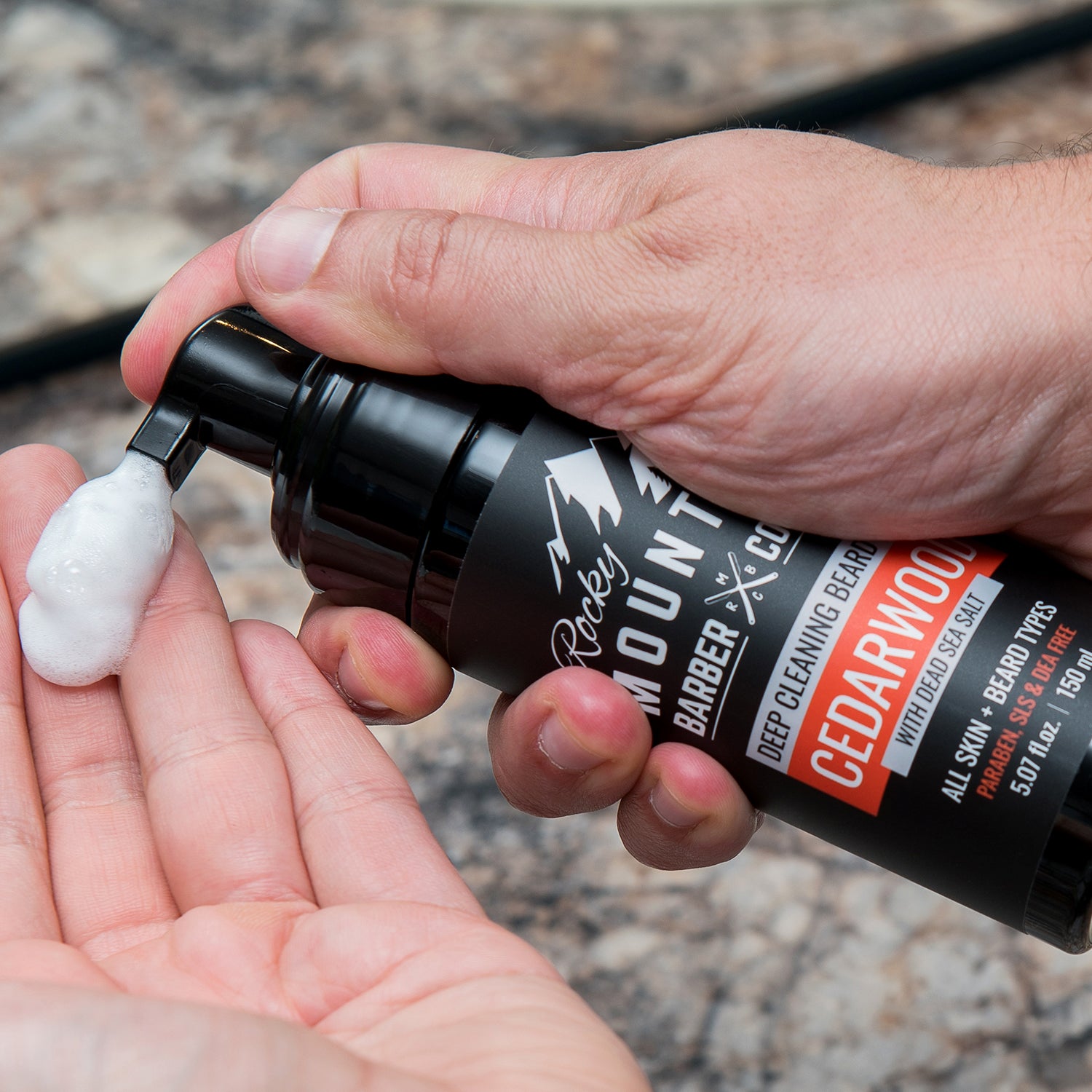 Foaming Cedarwood Beard Wash Being Pumped Onto Hand