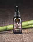 Rocky Mountain Barber Company Bamboo Beard Oil on Wooden Table with Bamboo