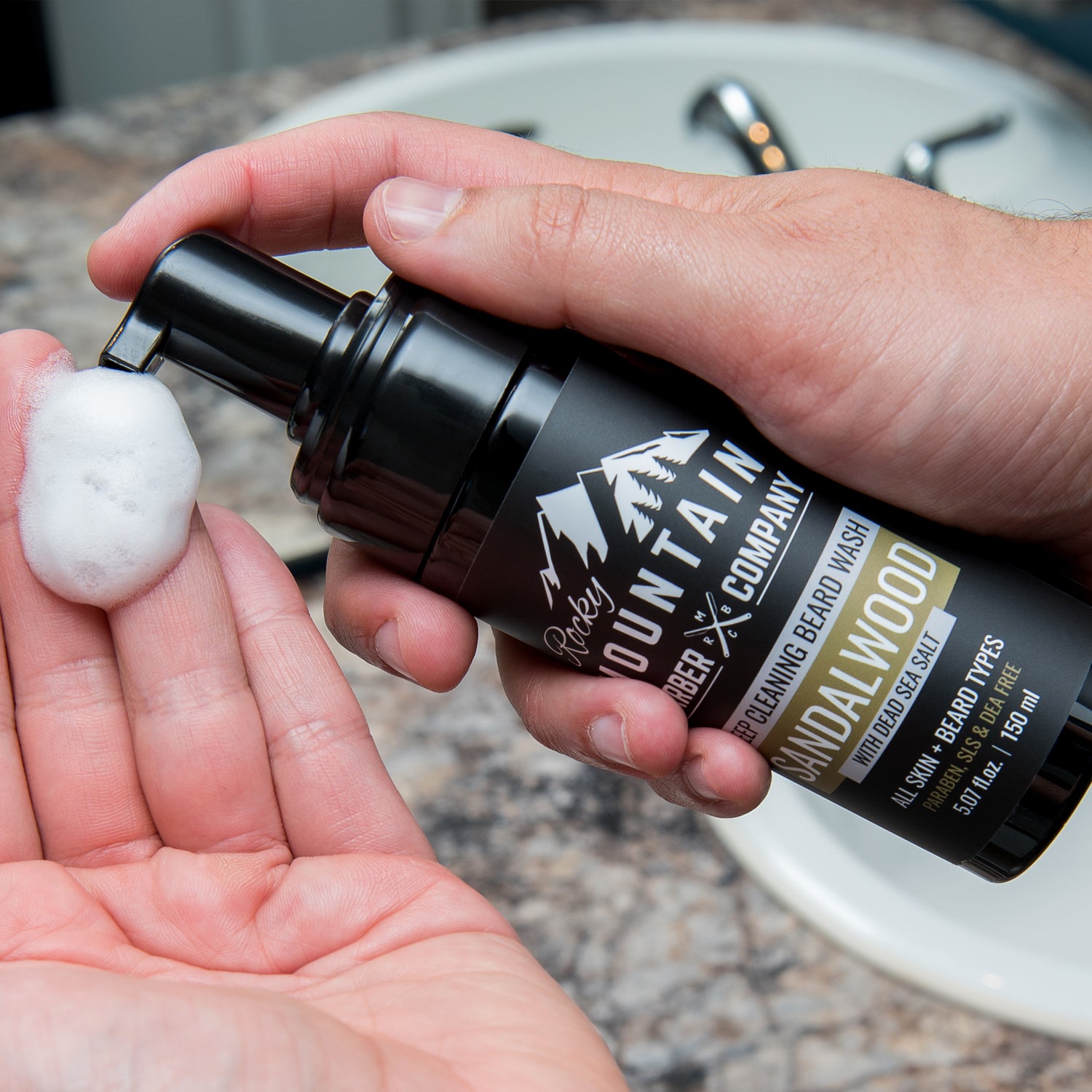 Foaming Sandalwood Beard Wash Being Dispensed Onto Hand